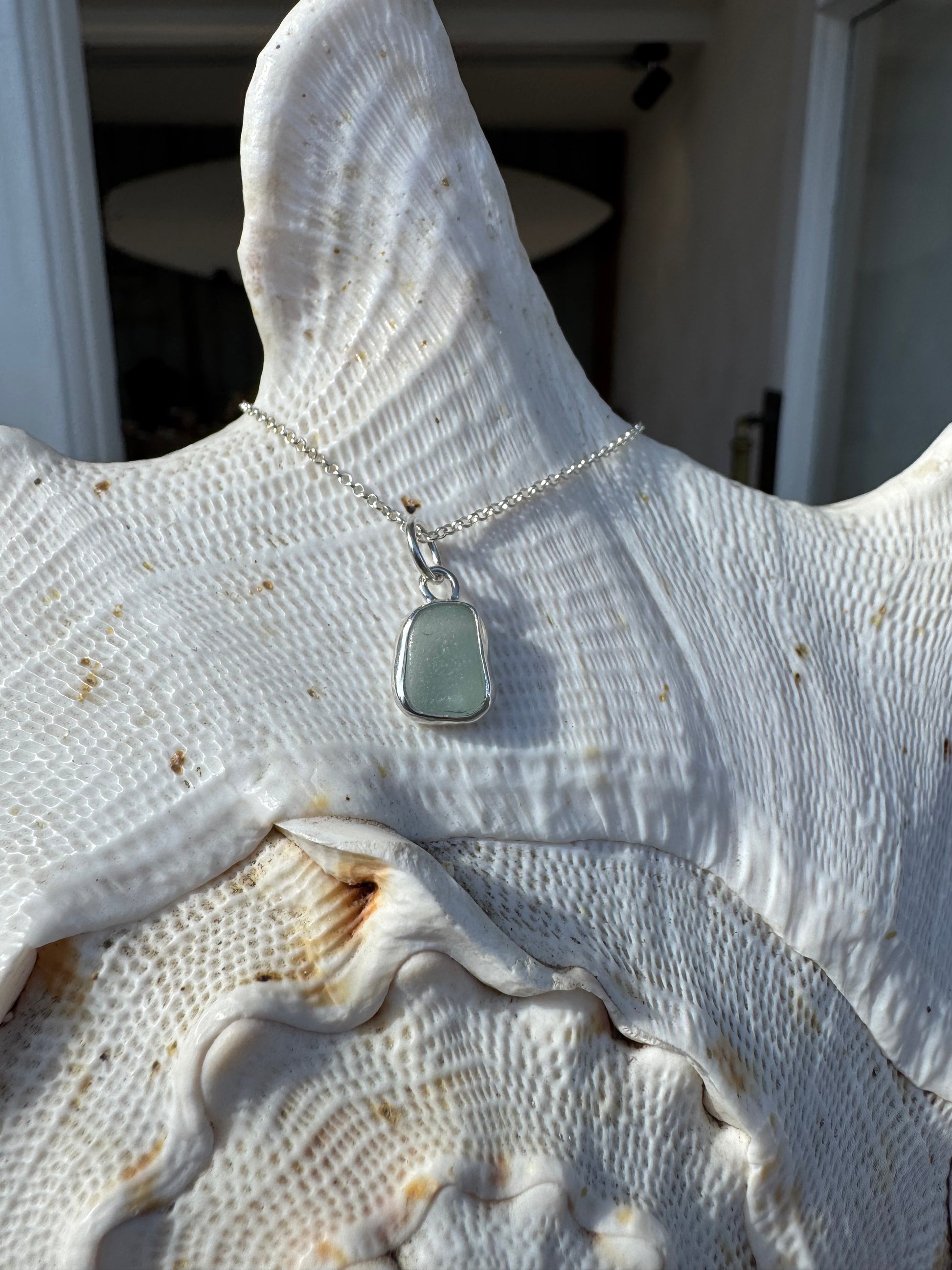 Close-up handmade sterling silver sea glass necklace