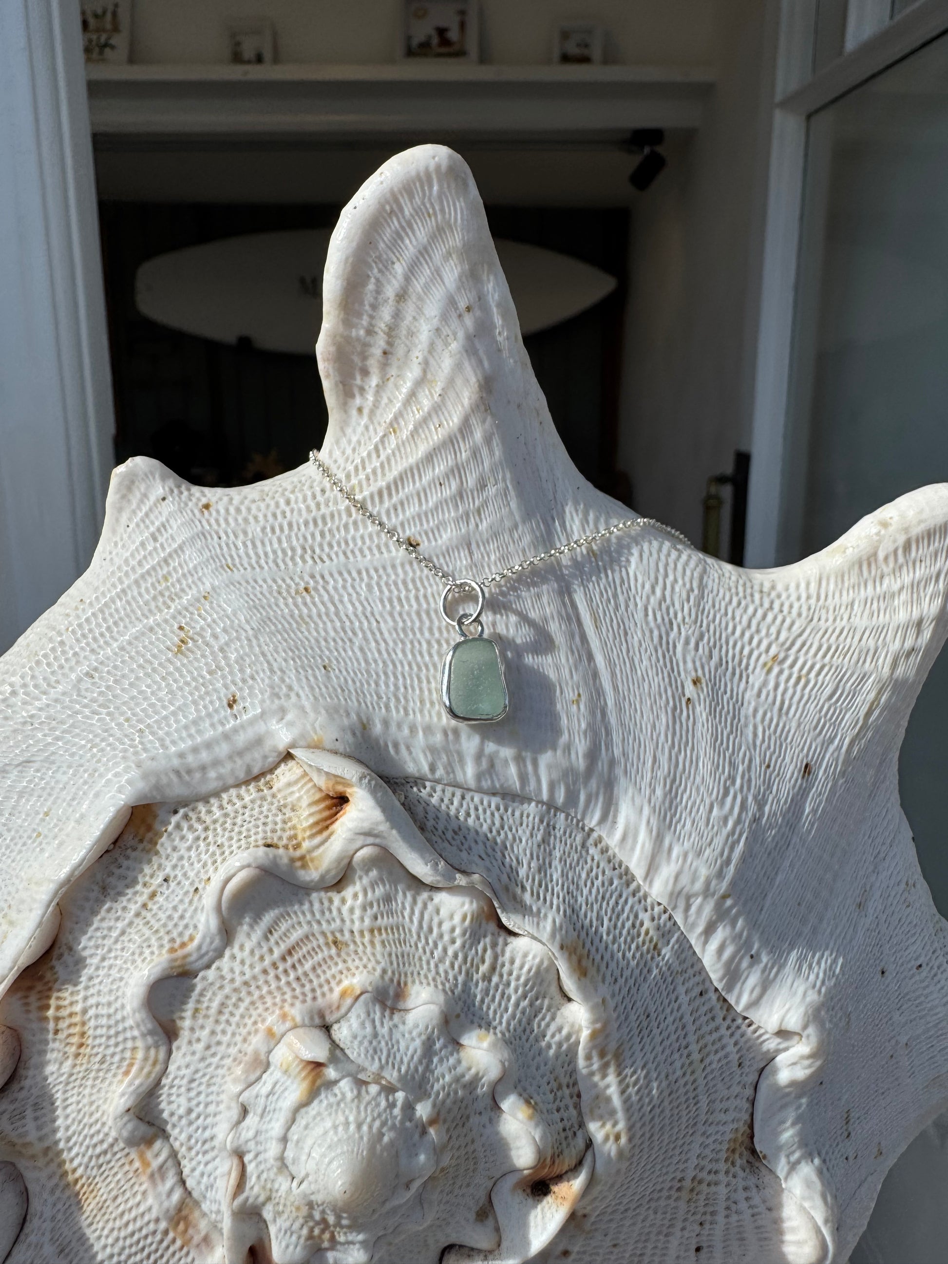 It’s light blue sea glass necklace, handmade